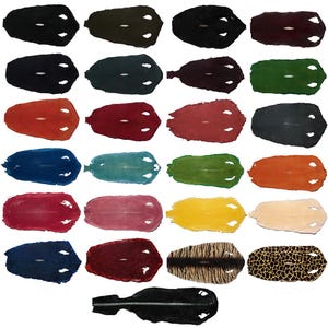 May include: A collection of stingray leather hides in various colors, including black, red, blue, green, and yellow. Each hide has a distinctive, textured surface with a central, lighter-colored eye-like pattern. The hides are arranged against a white background.