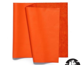 May include: Bright orange leather sheets, one folded, with a rough-textured back. The Newbury Leathers logo is in the bottom right corner. The leather appears smooth and vibrant.