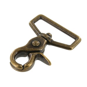 May include: Antique brass swivel hook with a rectangular loop. The hook has a spring-loaded clasp.