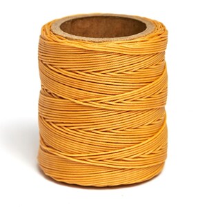 May include: A spool of yellow waxed thread.