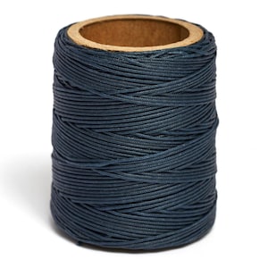 May include: A spool of dark blue waxed thread.