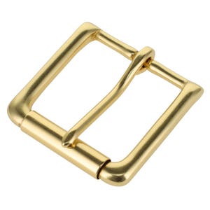 May include: A square-shaped belt buckle with a smooth, matte gold finish. The buckle features a rounded frame and a central prong that rests against the opposite side of the frame, designed for securing a belt strap through the open center.