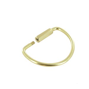 May include: A gold-toned metal key ring with a screw-on design. The ring is open and ready to be attached to keys.