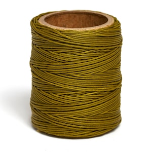 May include: A spool of olive green waxed thread.