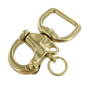 May include: A gold-colored swivel snap hook with a D-ring and a small key ring. The hook has a curved shape with a spring-loaded gate. The D-ring is rectangular. The key ring is small and circular.