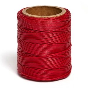 May include: A spool of red waxed thread for sewing and crafting.