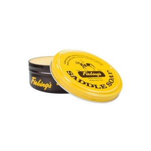 May include: A round, open container of saddle soap with a yellow lid. The lid is labeled "Fiebing's Saddle Soap" with a graphic of a horse and rider. The container is dark brown with the brand name in yellow.