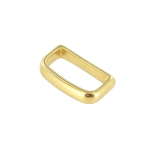 May include: A gold-colored rectangular metal buckle with rounded corners. The buckle is a simple, open-frame design, suitable for various crafting and accessory projects. The metal has a polished finish.