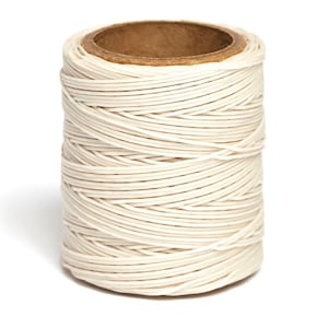May include: A spool of white waxed thread, wound tightly around a cardboard tube.
