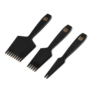 May include: Three black leather crafting tools with gold lettering. The tools have different shaped tips, including a comb-like tip, a pointed tip, and a forked tip.