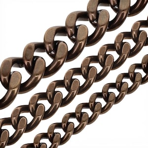 May include: Three strands of dark bronze-toned metal curb chains arranged diagonally. Each chain consists of interlocking oval links with a smooth, matte finish. The chains vary in thickness, showing a consistent metallic texture throughout.