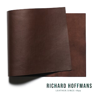 Peut inclure: Deux feuilles de cuir brun foncé, l'une pliée. Le dessous est brun plus clair. L'image comprend le texte "RICHARD HOFFMANS LEATHER SINCE 1899".