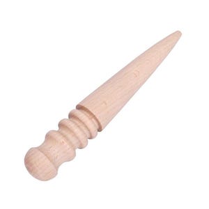 May include: A wooden leathercraft tool with a conical, pointed end and a rounded handle. The tool is made of light-colored wood and is designed for shaping and smoothing leather. The handle has a series of decorative ridges.