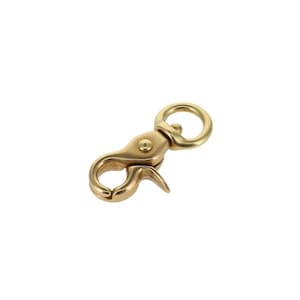 May include: A gold-toned metal swivel snap hook with a round ring. The hook is designed for attaching to a belt loop or other item.