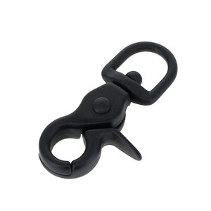 May include: A matte black metal swivel lobster clasp featuring a spring-loaded gate mechanism. The hardware includes a D-ring attachment point at the top and a circular hook at the bottom, designed for secure fastening in various craft applications.