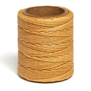 May include: A spool of tan waxed cotton thread.