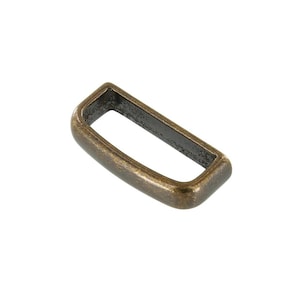 May include: A gold-toned metal belt loop with a rectangular shape.