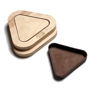 May include: A set of two triangular wooden serving trays. The larger tray is made of light wood and has a smaller, inset triangular tray. The smaller tray is made of dark brown material. The larger tray has the text "Broccolini" engraved on the bottom.