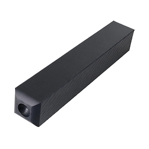 May include: A solid black rectangular object with a textured surface. One end features a circular hole. The object appears to be made of a dark material, possibly wood or a composite.