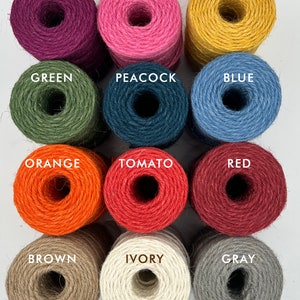 May include: Twelve spools of twine in various colors, including orchid, pink, gold, green, peacock, blue, orange, tomato, red, brown, ivory, and gray.