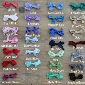 May include: A collection of 36 fabric swatches in various colors, including white, coral, lilac, medium blue, forest green, dark brown, off white, light pink, lavender, peacock blue, black, khaki tan, dusty rose, buttercream, royal purple, ivory, royal blue, gold, medium pink, dusty light blue, vintage ivory, maroon, dark navy, orange, bright red, bright yellow, light blue, mint, red, silver gray, cardinal red, peach, light aqua, moss green, green, steel gray, orange, bordeaux wine, blue, kelly green, and medium brown.