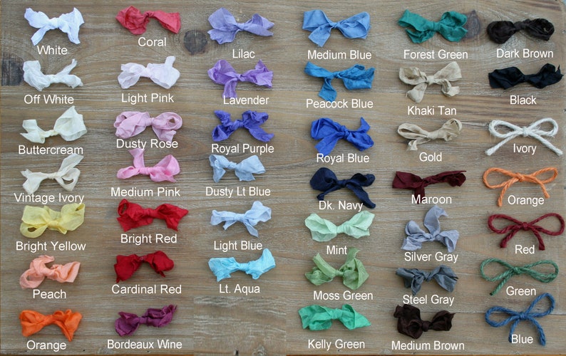 May include: A collection of 36 fabric swatches in various colors, including white, coral, lilac, medium blue, forest green, dark brown, off white, light pink, lavender, peacock blue, black, khaki tan, dusty rose, buttercream, royal purple, ivory, royal blue, gold, medium pink, dusty light blue, vintage ivory, maroon, dark navy, orange, bright red, bright yellow, light blue, mint, red, silver gray, cardinal red, peach, light aqua, moss green, green, steel gray, orange, bordeaux wine, blue, kelly green, and medium brown.