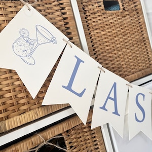 PRINTED Last Toast on the Coast Banner, or pick your own letters. Cocktail Pennants automatically included in all-print is a cornflower blue