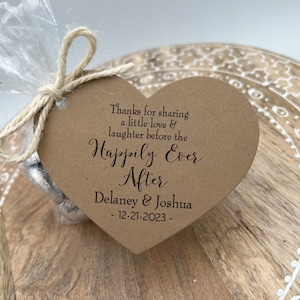 Puede incluir: Una tarjeta marr&oacute;n en forma de coraz&oacute;n con el texto "Thanks for sharing a little love & laughter before the Happily Ever After Delaney & Joshua - 12-21-2023 -" impreso en marr&oacute;n.