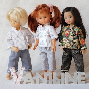 May include: Three dolls wearing different outfits. The doll on the left is wearing a plaid shirt and blue pants. The doll in the middle is wearing a white shirt with a floral pattern and gray pants with white polka dots. The doll on the right is wearing a black and gold patterned shirt and black pants.
