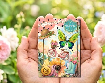 May include: A rectangular art print featuring a colorful illustration of a butterfly, a pink bicycle with a flower basket, a brown hat, a snail, and light blue rain boots. The design includes black polka dots and the text BLOOM.