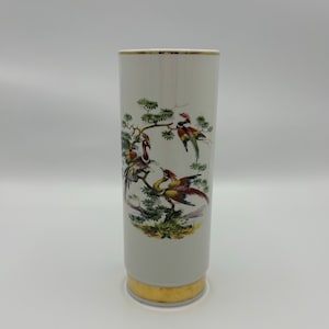May include: White ceramic vase with a gold rim and base. The vase features a colorful illustration of birds perched on a branch with green leaves.