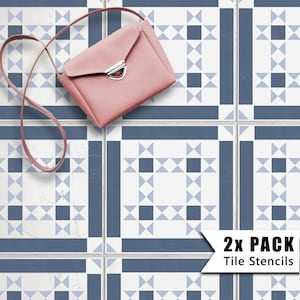 May include: Two pack of tile stencils featuring a geometric pattern of blue and white squares and triangles. The stencils are shown on a white tiled floor with a pink purse on top.