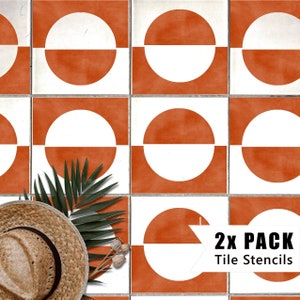 May include: A set of two tile stencils featuring a geometric design with a white circle divided in half by a horizontal line, set against a burnt orange background. The stencils are labelled "2x PACK Tile Stencils".