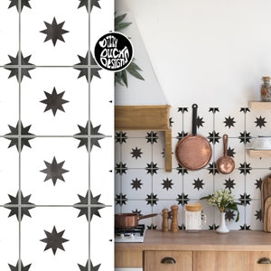 Op de afbeelding: Zwarte en witte stervormige tegelpatroon keukenachterwand met een houten aanrechtblad en een roestvrijstalen kookplaat. De achterwand is gemaakt van peel-and-stick behang.