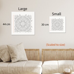 May include: Two square wall art prints featuring a geometric mandala design in black and white. The larger print measures 44 cm and the smaller print measures 30 cm.