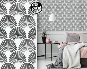 May include: A black and white geometric wallpaper pattern with a fan design. The wallpaper is shown in a bedroom setting with a bed, nightstand, and plant.