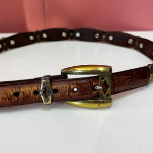 May include: A set of three ceramic mugs with a speckled, matte finish. The mugs are in shades of cream, light gray, and dark gray. Each mug has a simple, minimalist design, perfect for coffee or tea.