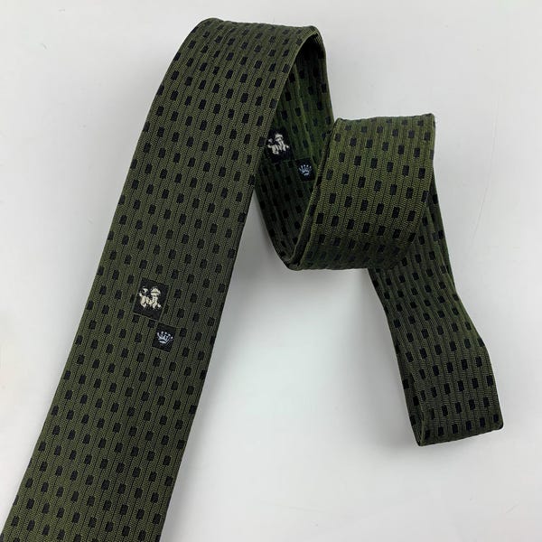 Early 1960's Mod Tie - Narrow Profile - HAROLD A. BERGGUIST Label - Lion with a Crown Crest on an Olive with Tiny Black Dots base