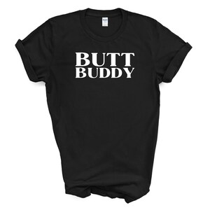 May include: Black t-shirt with white text that reads "BUTT BUDDY".