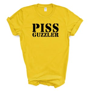 May include: Yellow t-shirt with black text that reads "PISS GUZZLER" in a bold, blocky font.