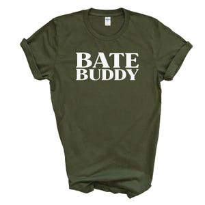 May include: A green t-shirt with the text "BATE BUDDY" printed in white.