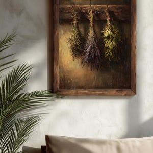 A moody oil painting of three tied bundles of dried herbs hanging from a wooden beam against a textured umber background.