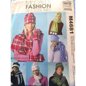 May include: A McCall's Fashion Accessories pattern envelope featuring various hat and scarf designs. The image showcases several women modeling different fleece hat and scarf sets in various colors and patterns, including plaid and solid colors.