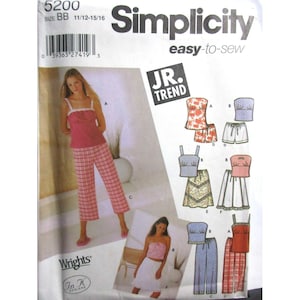May include: Simplicity sewing pattern 5200 for Jr. Trend clothing. The pattern includes designs for tops, shorts, skirts, and pants. The main image shows a pink top and plaid pants. The pattern size is BB 11/12-15/16.