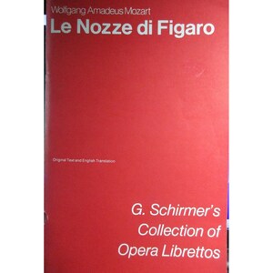 May include: A red book cover with the title "Le Nozze di Figaro" by Wolfgang Amadeus Mozart. The book is part of G. Schirmer's Collection of Opera Librettos.