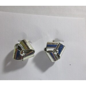 May include: A pair of silver earrings with a knotted design. The earrings are made of metal and have a shiny finish.