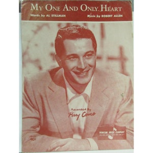 May include: A vintage sheet music cover featuring a smiling man in a suit. The title of the song is "My One And Only Heart" with the words by Al Stillman and music by Robert Allen. The sheet music is recorded by Perry Como.