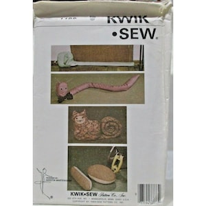 May include: A Kwik Sew sewing pattern featuring images of stuffed animal designs, including a snail, worm, and cat. The pattern includes the text "KWIK SEW" and "DESIGNED BY KERSTIN MARTENSSON". The pattern is from Kwik Sew Pattern Co., Inc.
