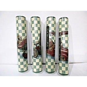 May include: Four rolls of wallpaper with a green and white checkered pattern. Each roll features a vintage car and the text "SA Maxwell Co."
