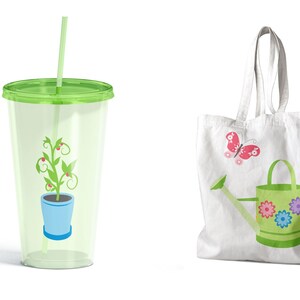 May include: A green reusable cup with a straw and a green plant with red berries in a blue pot. A white tote bag with a green watering can with pink, purple, and blue flowers and a pink butterfly.